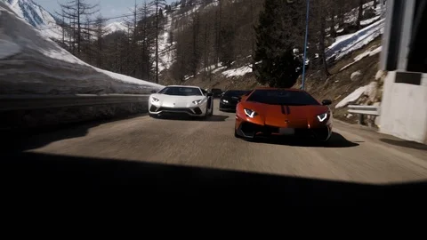 Rolling tracking shot driving Lamborghini Aventador Huracan mountain road Stock Footage 127375852