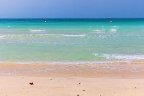 Rolling turquoise waves ashore in Dubai Stock Photos