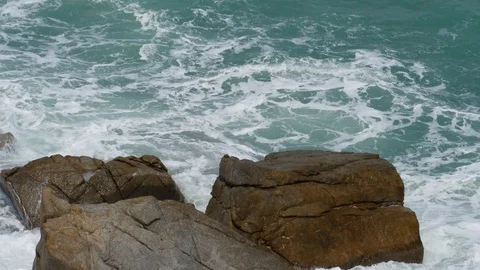 Rolling wave slamming on rocks of coastline Stock Footage 127532676