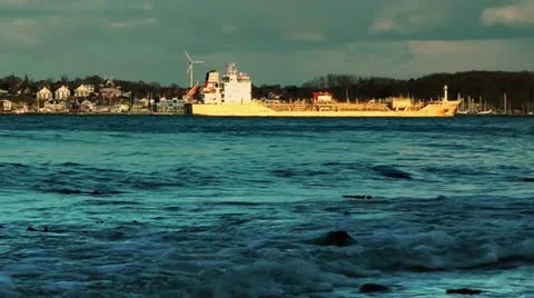Rolling waves and cargo ship on coastline of Laboe, Kiel, Germany, panning Stock Footage 11144579