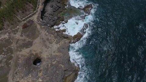 Rolling waves and overhead cliff rocky coastline Stock-Footage 88567040
