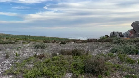 Rolling waves to the beach sea views and massive beach boulders Stock Footage 274708181