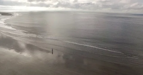 Rolling waves on a cloudy day at the beach Stock Footage 76676767