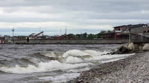 Rolling Waves Crash Against the Stony Shore of Lake Ontario in the Morning Stock Footage 346051778