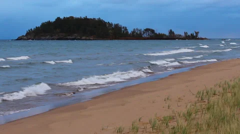 Rolling waves in front of island Stock Footage 34338263
