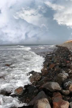 Rolling waves on pebbled coastline Stock Photos