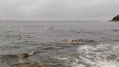 Rolling waves in water of cloudy beach ocean, 4K Stock Footage 122321264