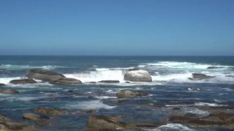 Rolling white surf waves of the Atlantic Ocean crashing on huge sea boulders Stock Footage 305022776