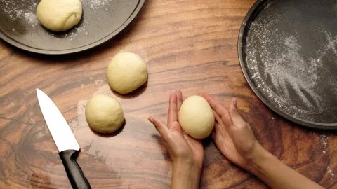 Rolling yeast dough to make traditional pan de muerto Stock Footage 281459910