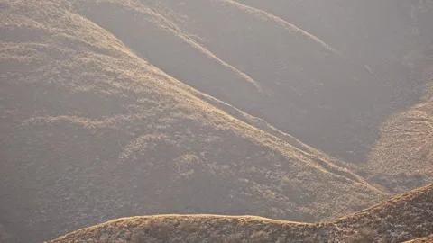 Rolling Yellow Grass Mountains with Changing Light and Shadow Stock-Footage 326426124