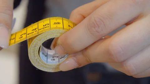 Rolling Up the  Yellow Tap Measure Stock Footage 113324682