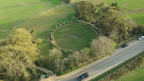 Rollright Stone Circle Drone Tilt-Up Reverse, Sunset, Oxfordshire, UK, 4K Stock Footage 172507197