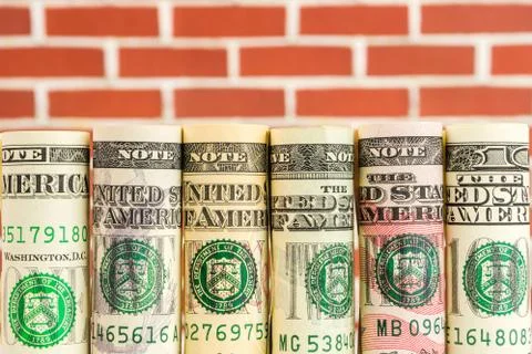 Rolls of american dollar banknotes in one row Stock Photos