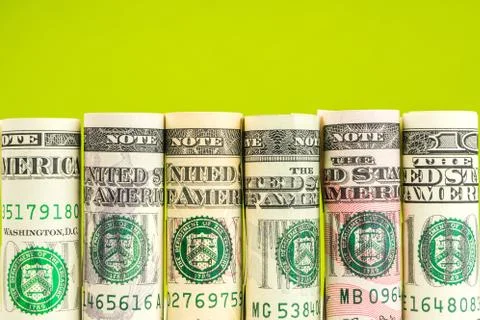 Rolls of american dollar banknotes in one row Stock Photos