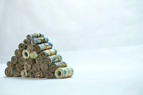 Rolls and Bundles of Naira Cash local currencies in a pyramid heap Stock Photos
