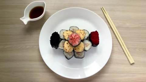 Rolls and sushi folded in the form of a cake on a white plate Stock Footage 131745048