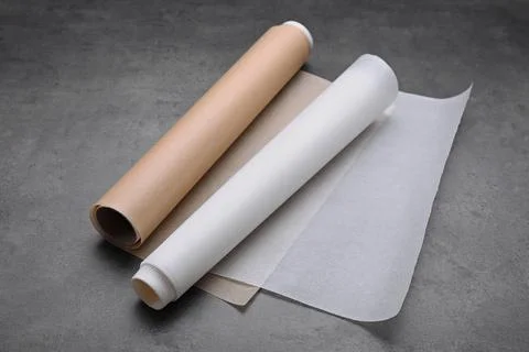 Rolls of baking paper on grey table Stock Photos