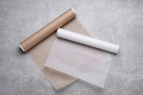 Rolls of baking paper on light grey table, flat lay Stock Photos