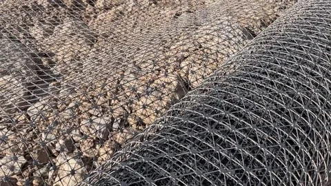 Rolls of black plastic geogrid prepared for reinforcement the roadbed Stock Footage 237828361