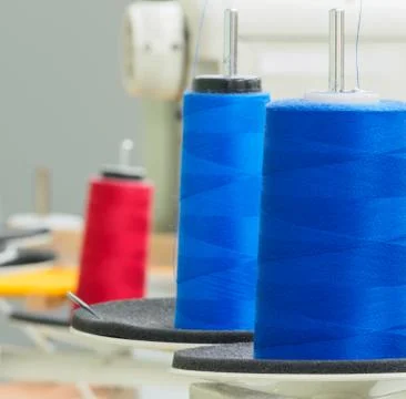 Rolls of blue cotton thread for sewing with overlock machine. Stock Photos