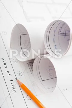 Rolls of blueprints and pencil Stock Photos