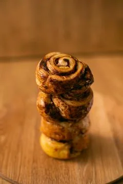 Rolls Cinnabon cinnamon and sugar, on a wood round plate Stock Photos