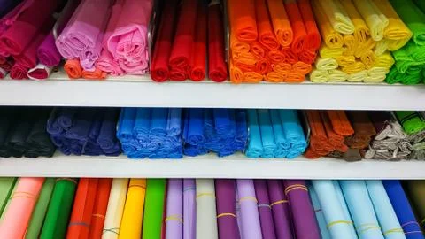 Rolls of colored craft paper whatman and foamiran in the store on the shelves Stock Photos