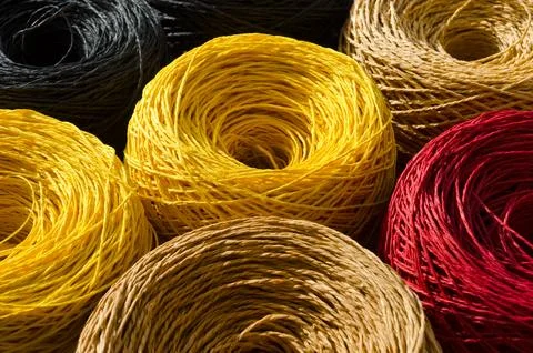 Rolls of colored raffia close-up. Eco material for handmade work. Stock Photos