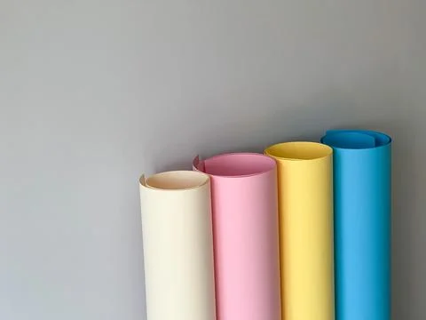 Rolls of colourful paper on a simple background Stock Photos
