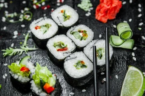 Rolls with cucumber on a dark background Stock Photos