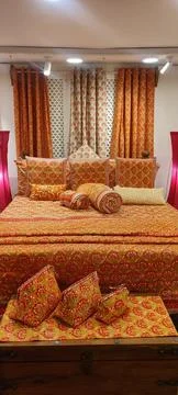 Rolls of fabric displayd on a double bed in a factory shop Foto stock