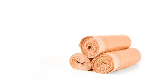 Rolls of garbage trash bin bag isolated on white background Stock Photos