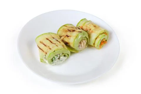 Rolls of grilled vegetable marrow with different filling on dish Stock Photos