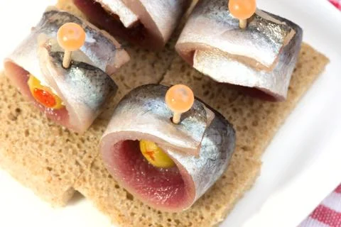 Rolls of herring with olives Stock Photos