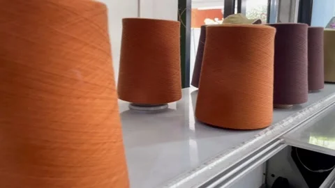 Rolls of knitting yarn in various colors on a sewing machine for making clothes Stock Footage 282331784