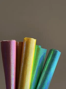 Rolls of multi-colored bright shiny paper Stock Photos