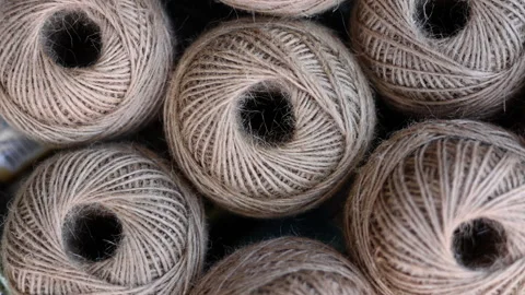 Rolls of natural hemp wire for parcel twine, string, packing or diy Stock Footage 253384780