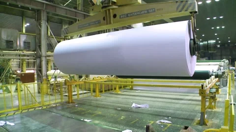 Rolls of paper leave the paper machine and are carried by crane Stockbeeldmateriaal 258145742
