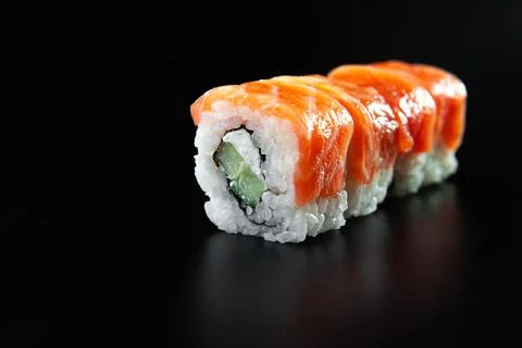 Rolls of red fish on a black background isolate. Sushi on a black background Stock Photos