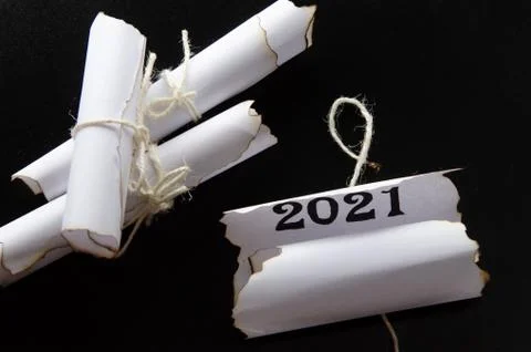 Rolls of sheets of paper on a black background. Inscription 2021 库存照片