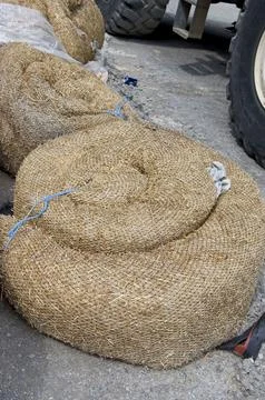 Rolls of straw for sowing grass Stock Photos