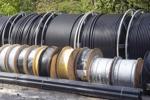 Rolls of telecommunication cable coiled up on construction site Stock Photos