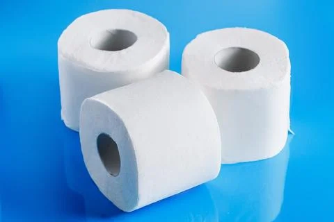 Rolls of toilet paper on a blue background. Panic purchase of essential goo.. Stock Photos