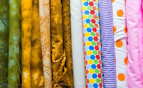 Rolls of various fabric styles  in a drapery store Stock Photos
