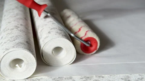 Rolls of wallpaper and roller. Stock Footage 104760193