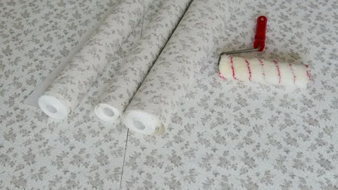 Rolls of wallpaper and roller. Stock Footage 104760388