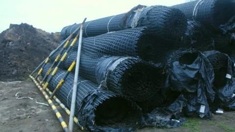 Rolls of wire mesh for erosion control at construction site Stock Footage 310521309