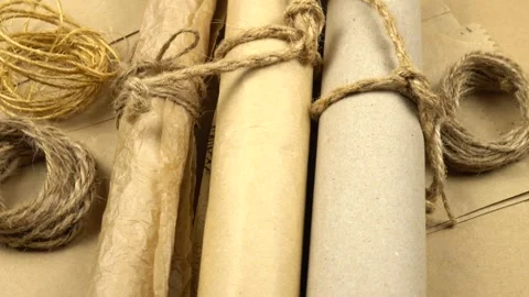 Rolls of wrapping paper, various twines for wrapping, background Stock Footage 321758119