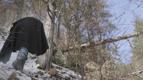 Roman centurion falling near the trunk of a tree in the snow-covered forest, Stock Footage 128723862