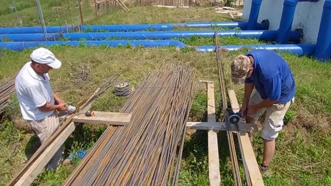 ROMAN, ROMANIA - 06/26/2021: Workers Using Angle Grinder To Cut Rebar. 4K Video stock 156208832